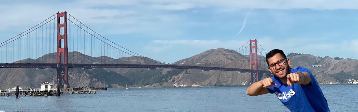 NSE student posing with fingers pointed golden gate bridge in the backdrop